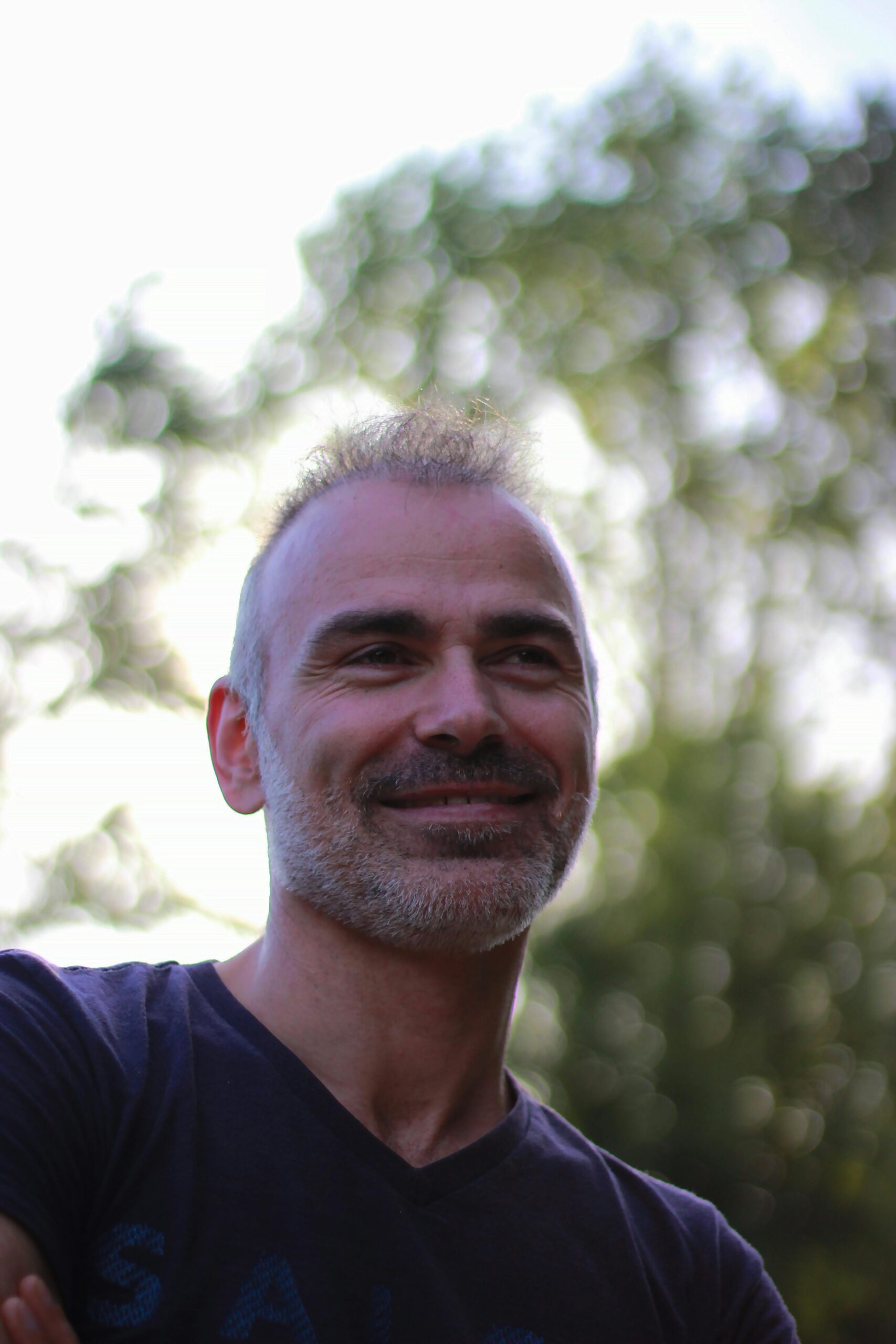 A cheerful man enjoys a sunny day outdoors in Braga, Portugal.